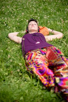 beautiful hipster short hair woman listening music in the park in the city