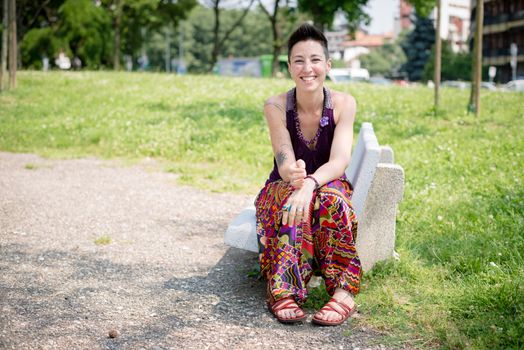 beautiful hipster short hair woman in the park in the city