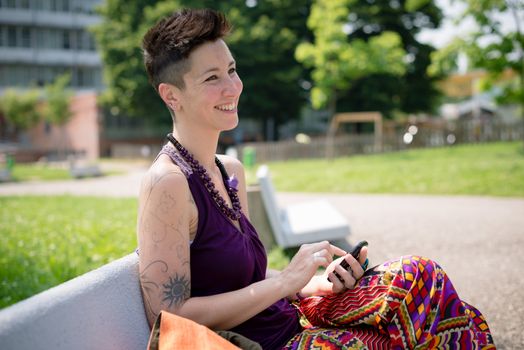 beautiful hipster short hair woman in the park in the city