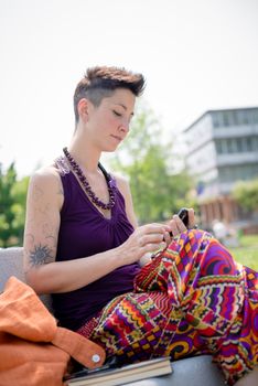 beautiful hipster short hair woman in the park in the city