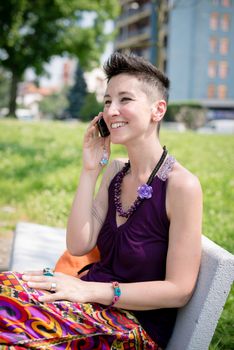 beautiful hipster short hair woman in the park in the city