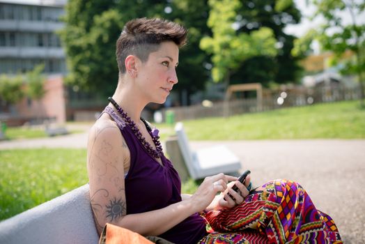 beautiful hipster short hair woman in the park in the city