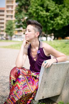 beautiful hipster short hair woman in the park in the city