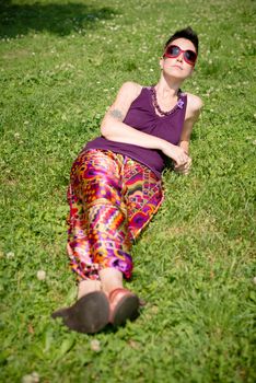 beautiful hipster short hair woman in the park in the city