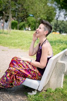 beautiful hipster short hair woman in the park in the city
