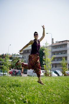 beautiful hipster short hair woman in the park in the city