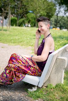 beautiful hipster short hair woman on the phone in the park in the city