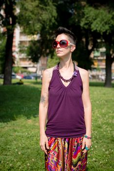 beautiful hipster short hair woman in the park in the city