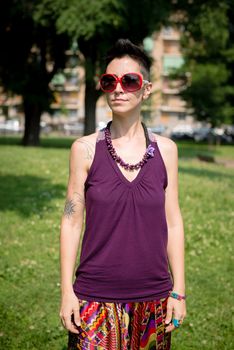 beautiful hipster short hair woman in the park in the city