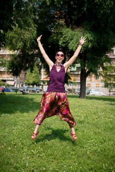 beautiful hipster short hair woman in the park in the city