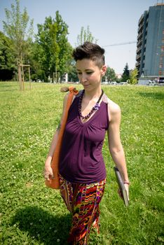 beautiful hipster short hair woman in the park in the city