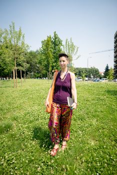 beautiful hipster short hair woman in the park in the city