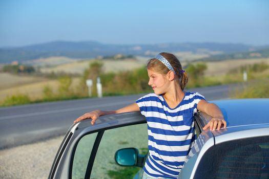 Beautiful girl traveling by car. Vacations in Tuscan. Italy