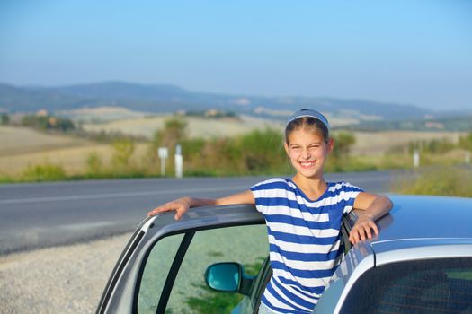 Beautiful girl traveling by car. Vacations in Tuscan. Italy