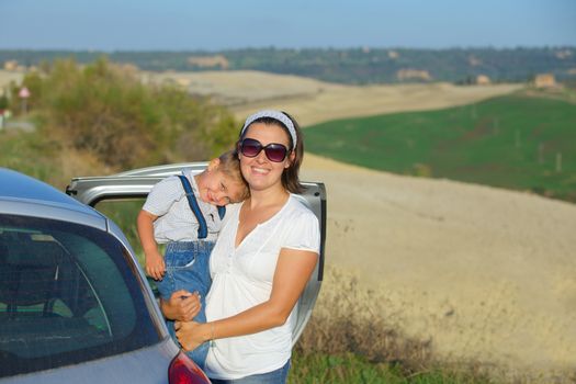 Mother with her son traveling by car. Vacations in Tuscan. Italy