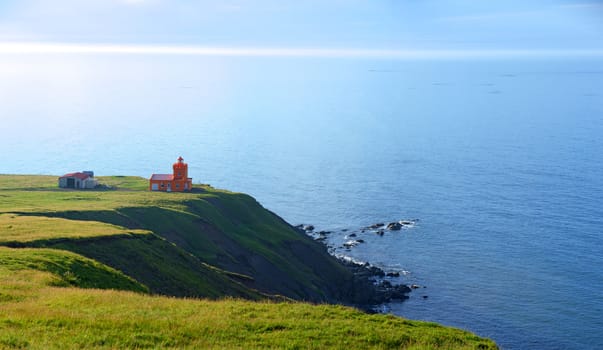 North Iceland Sea Landscape with Orange Lighthouse and Blue Sky. Panorama