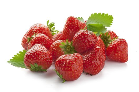 Handful of red fresh strawberries with green leaves