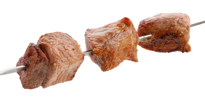 Hot roasted pork meat on the metal skewer