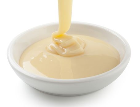 Condensed milk flowing in white plate