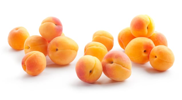Scattering of fresh apricots on the white background