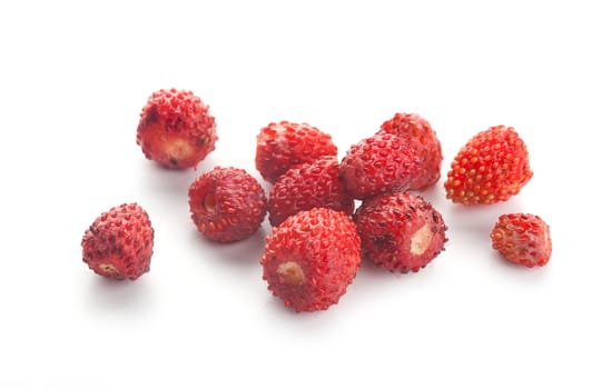 Handful of fresh wild strawberries on the white background