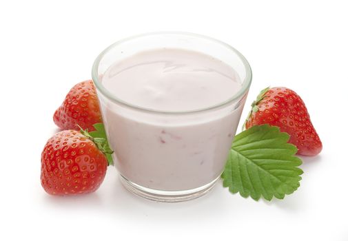 Glass with yoghurt and strawberries with leaf