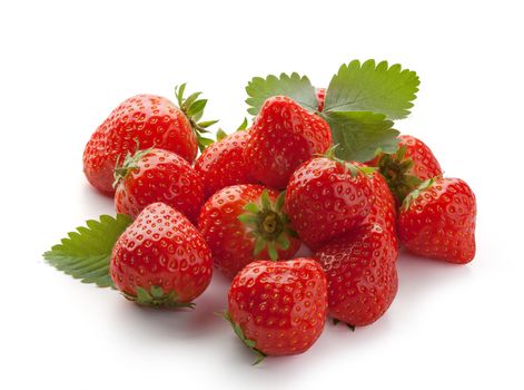 Handful of red fresh strawberries with green leaves