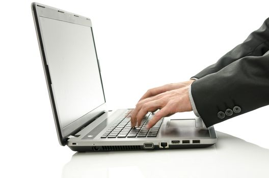 Detail of blurred hands using laptop. Isolated over white background.