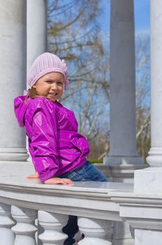 Little smiling girl on bench at park