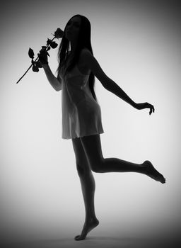 Portrait of young girl with rose flower (monochrome)