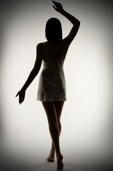 Silhouette of young girl on gray background