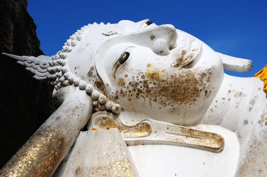 Giant Reclining Buddha at an Ancient buddhist wat in Ayutthaya, Thailand