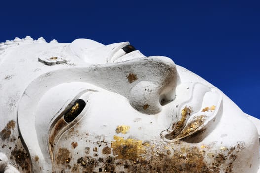 Giant Reclining Buddha face at an Ancient buddhist wat in Ayutthaya, Thailand