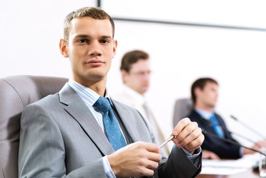 Portrait of a businessman, in the background colleagues communicate with each other