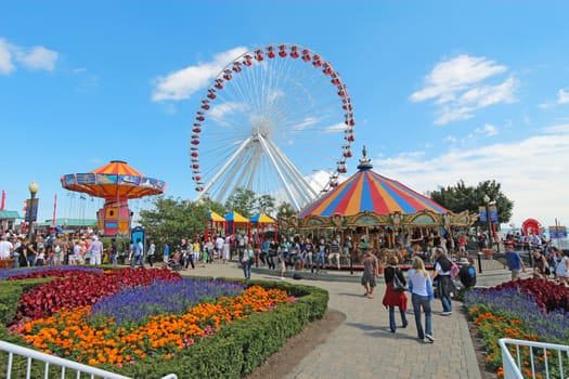 CHICAGO, ILLINOIS - SEPTEMBER 4: Tourists at the amusement park on Navy Pier in Chicago, Illinois on September 4, 2011. The Pier is a popular destination with many attractions on Lake Michigan.