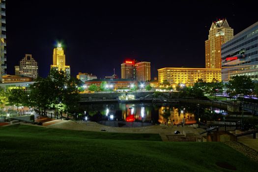 HDR image of Providence Place in the center of the capital of Rhode Island with reflections of buildings on the water at night