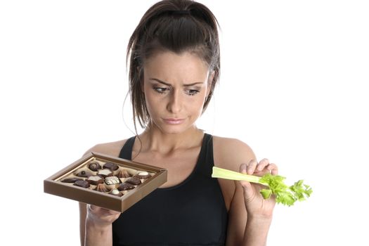 Model Released. Woman Holding Celery and Chocolates