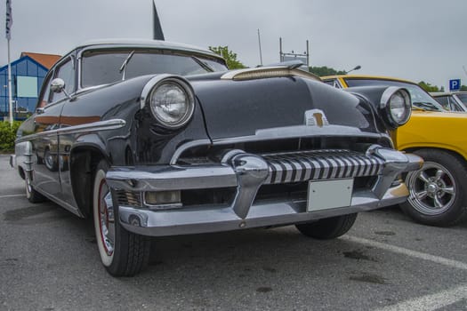 The image is shot at a fish-market in Halden, Norway where there every Wednesday during the summer months are held classic American car show.