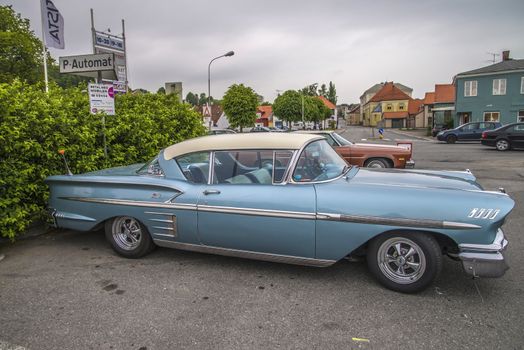 The image is shot at a fish-market in Halden, Norway where there every Wednesday during the summer months are held classic American car show.