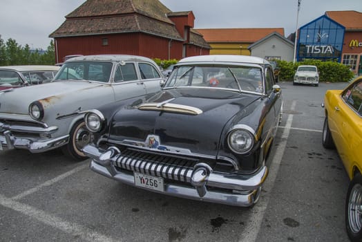 The image is shot at a fish-market in Halden, Norway where there every Wednesday during the summer months are held classic American car show.