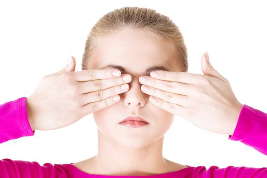 Young teen woman covering her face with hands, isolated on white