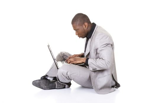 Successful businessman working on laptop, isolated on white