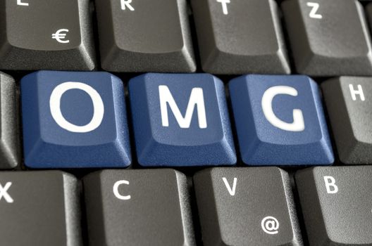 Abbreviation OMG written with blue keys on computer keyboard.