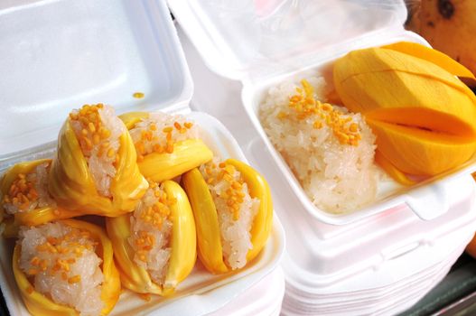 Steamed sticky rice with mongo fruits as Thai snack food
