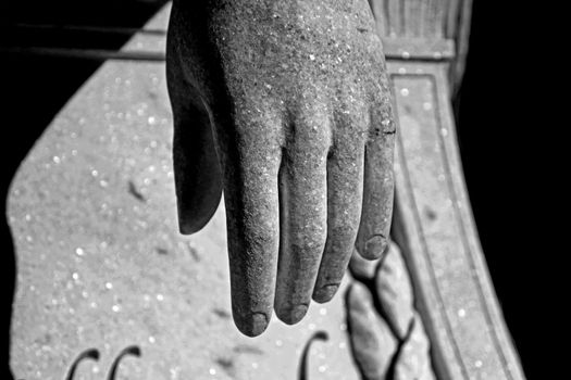 Black and white view of crying angel monument close up view of hand