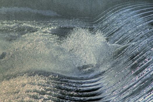 Close-up view of water flowing over a damn