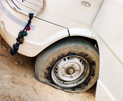 Flat tire of white car