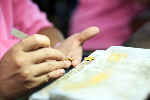 Goldsmith working with a thai traditional gold