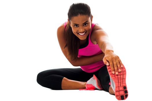 Beautiful young girl doing stretching exercise over white