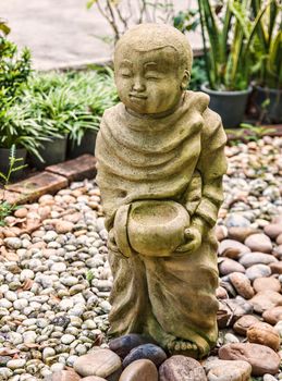 Funny traditional Thai garden monk sculpture